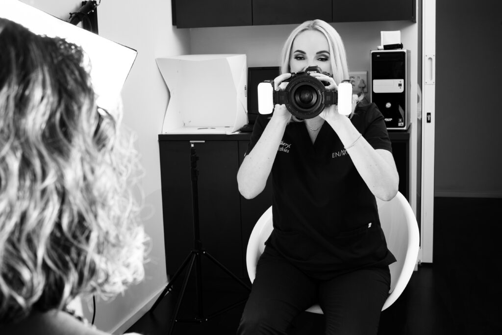 Dr. Sheryl Smithies holding a camera with macro flash lighting to photograph a patient's smile for digital treatment planning.